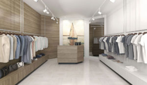 Modern clothing store interior with neatly organized garments and a central display area.