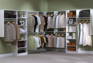 Organized walk-in closet with neatly arranged clothes and storage compartments.