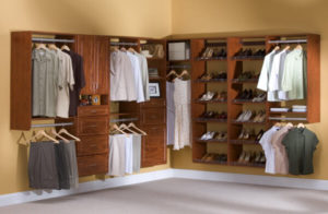 An organized walk-in closet featuring an array of clothes, shoes, and storage spaces.