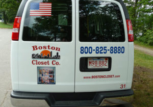 A company vehicle for Boston Closet Co. with branding, contact information, and an American flag displayed on the back.