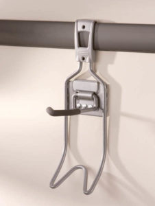 Metal window safety lock mounted on a horizontal bar.
