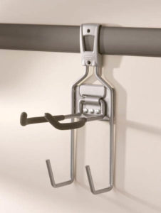 Metal clamp with hooks attached to a horizontal pole.