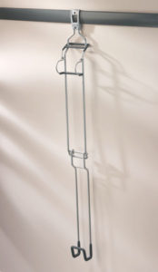 Empty clothes hanger casting a shadow on a wall.