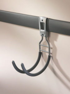 Metal hook attached to a horizontal rail, likely used for hanging items.