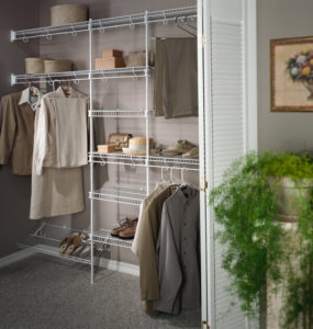 Organized closet featuring neatly arranged clothes and storage baskets on wire shelving.