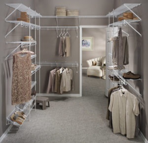 A well-organized walk-in closet with clothing and storage shelves.