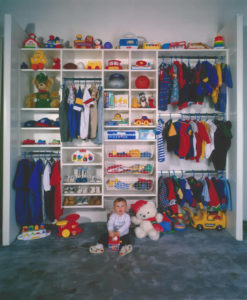 Children's wardrobe with neatly organized clothes, toys, and accessories.