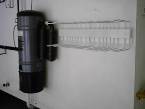 Wall-mounted hand sanitizer dispenser with dispensing lever and drip guard.