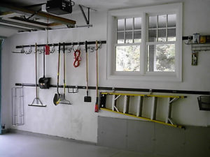 Neatly organized garage with tools and equipment hung on the wall.
