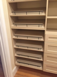 Empty wooden shelves built into a corner, awaiting items to be placed on them.