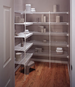 A well-organized pantry with neatly arranged shelves holding various kitchenware and containers.