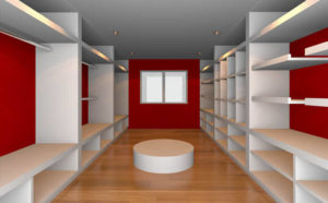 Modern empty retail shop interior with white shelves and a red accent wall.