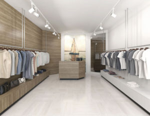 Modern clothing boutique interior with neatly organized garments and accessories on display.