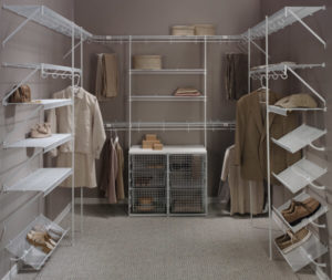 Organized walk-in closet with neatly arranged clothes and storage solutions.