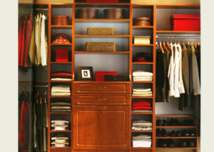 Organized walk-in closet with neatly arranged clothes and accessories.