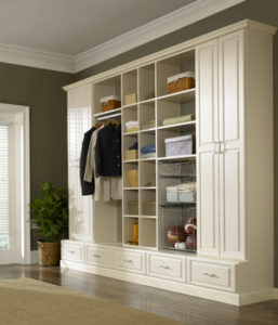 Well-organized closet with shelves, hanging clothes, and storage baskets.