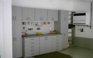 A tidy, modern kitchen with gray cabinetry and open shelves displaying various items.