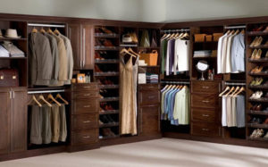 A well-organized walk-in closet with assorted clothing and accessories.