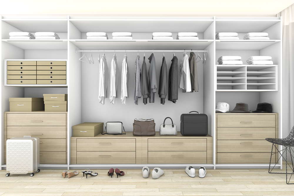 Neatly organized walk-in closet with clothes, shoes, and storage compartments.