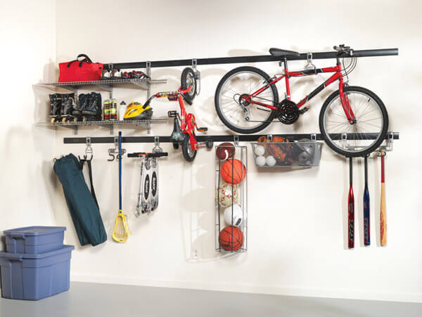 Organized garage storage system with mounted bike, sports equipment, and tools.