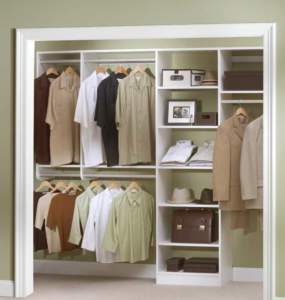 Organized walk-in closet with neatly arranged clothes and accessories.