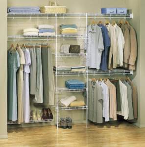 Organized closet with clothes neatly arranged on hangers and shelves.