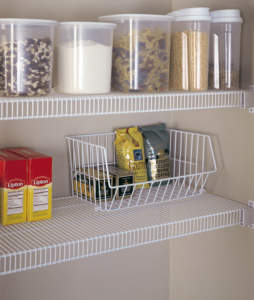 Organized pantry shelves with clear containers and wire baskets containing food items.