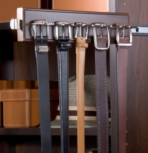 A selection of leather belts neatly hung on a closet organizer.