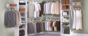 Neatly organized walk-in closet with a selection of hanging clothes and storage shelves.
