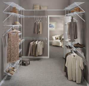Organized walk-in closet with neatly arranged clothes and shoes.