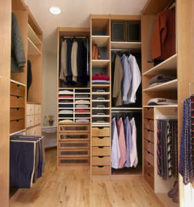 Well-organized walk-in closet with various sections for clothes and accessories.