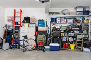 Organized garage with various items neatly stored on shelves and in containers.