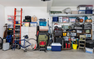 Organized garage with various items neatly stored on shelves and in containers.