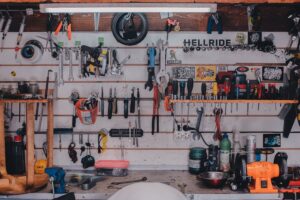 A highly organized workshop with tools neatly hung on the wall and shelves storing equipment.