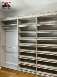 Custom-built empty shelving unit for closet organization in a clean room by Boston Closet Co.