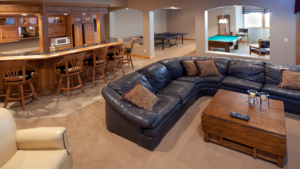 Spacious basement Man Cave with seating area, bar, and gaming tables.