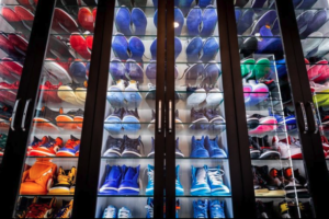 Closet display of various colorful sneakers on shelves.