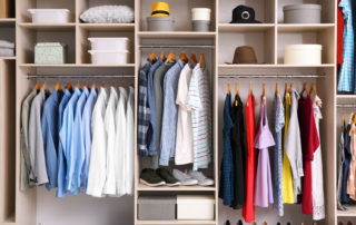 Organized closet with neatly arranged clothes and accessories on shelves and hangers, enhanced by closet organizers.