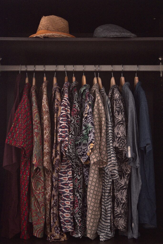 hats and shirts hanging in custom reach-in closet 