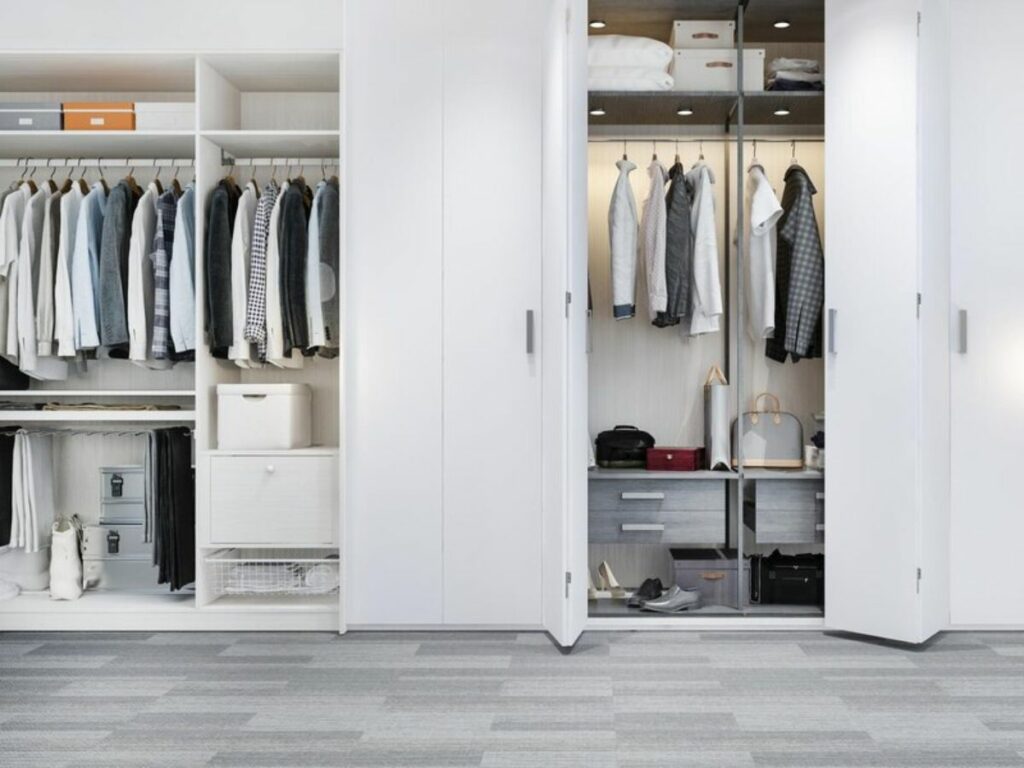 A tidy, modern mudroom with open organizers revealing neatly organized clothes and accessories.