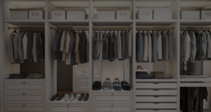 A well-organized walk-in closet with neatly arranged clothes and shoes.